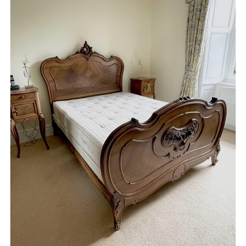 3131 - A French walnut bed, late 19th century, the foot and head with carved decoration, complete with side... 