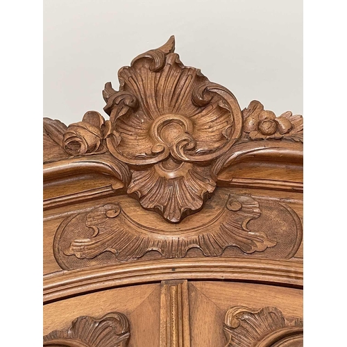 3132 - A French walnut armoire, late 19th century, with carved decoration, the two mirror doors enclosing a... 