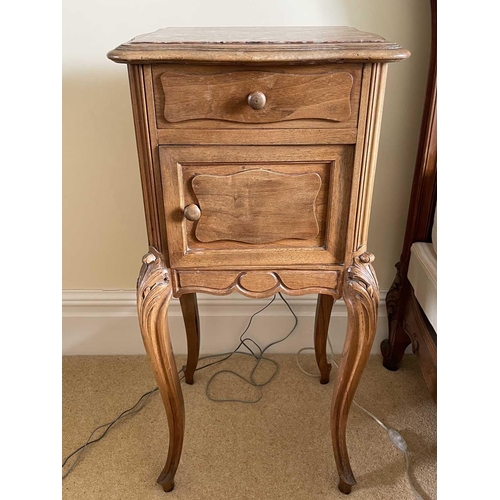 3133 - A French walnut bedside cupboard, late 19th century, with inset marble top above a drawer and cupboa... 