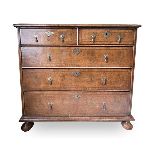 3134 - A George II walnut chest of two short and three long drawers, with replacement pear drop handles and... 