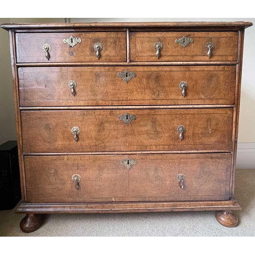 3134 - A George II walnut chest of two short and three long drawers, with replacement pear drop handles and... 