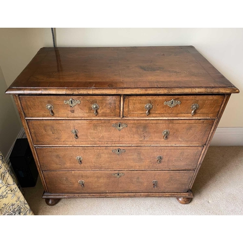 3134 - A George II walnut chest of two short and three long drawers, with replacement pear drop handles and... 