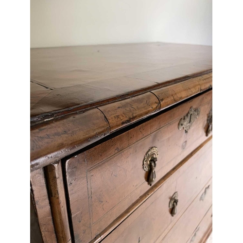 3134 - A George II walnut chest of two short and three long drawers, with replacement pear drop handles and... 