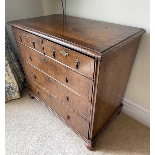 3134 - A George II walnut chest of two short and three long drawers, with replacement pear drop handles and... 