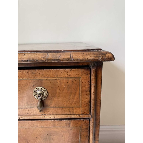 3134 - A George II walnut chest of two short and three long drawers, with replacement pear drop handles and... 