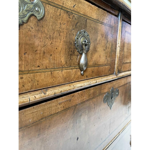 3134 - A George II walnut chest of two short and three long drawers, with replacement pear drop handles and... 