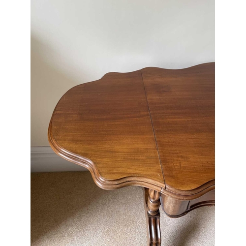 3135 - A French walnut serpentine shaped sofa table, circa 1880, fitted with two drawers and raised on turn... 