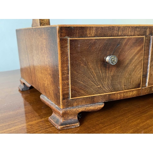 3136 - A George III mahogany and rosewood banded dressing table mirror, the bow front base fitted three dra... 