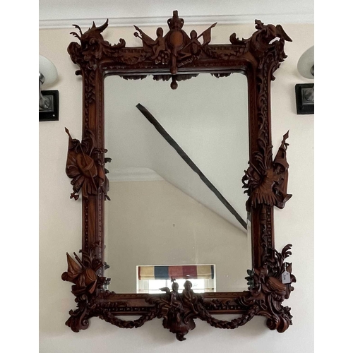 3143 - A mahogany ornate wall mirror, later 20th century, the frame carved with figures, dragons and milita... 