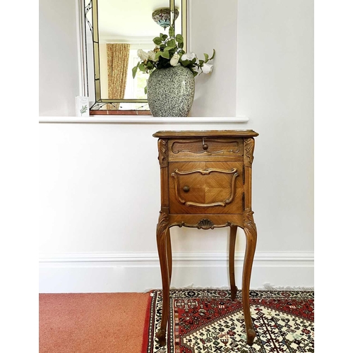 3146 - A French walnut bedside cupboard, late 19th century, with marble top above a door and a drawer on ca... 