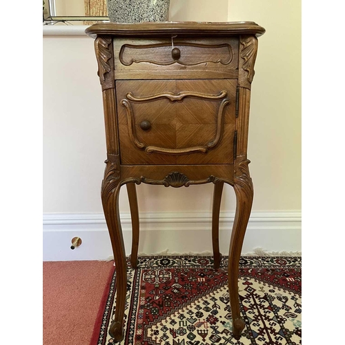 3146 - A French walnut bedside cupboard, late 19th century, with marble top above a door and a drawer on ca... 