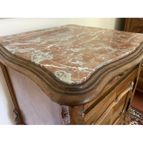 3146 - A French walnut bedside cupboard, late 19th century, with marble top above a door and a drawer on ca... 