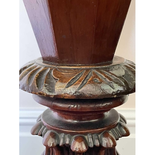 3147 - A Victorian walnut and inlaid sewing table, the circular top raised on a tapered and carved column a... 