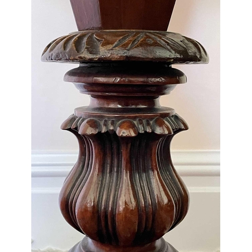 3147 - A Victorian walnut and inlaid sewing table, the circular top raised on a tapered and carved column a... 