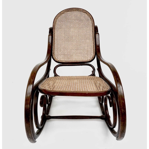 3155 - A mid 20th century bentwood rocking chair with caned back and seat. Height 83cm, total depth 104cm, ... 