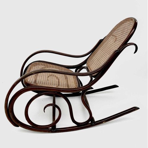 3155 - A mid 20th century bentwood rocking chair with caned back and seat. Height 83cm, total depth 104cm, ... 