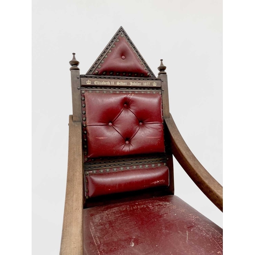 3163 - A pair of oak throne chairs, with leather upholstered backs and seats, produced to commemorate the 1... 