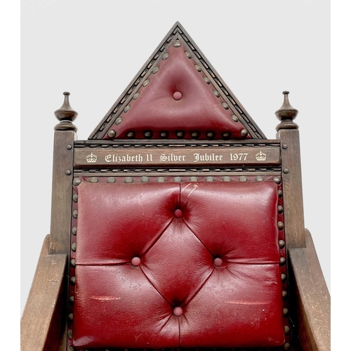 3163 - A pair of oak throne chairs, with leather upholstered backs and seats, produced to commemorate the 1... 