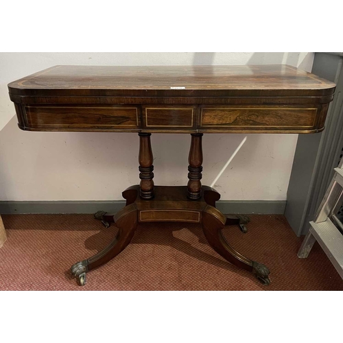 3174 - A Regency brass inlaid rosewood fold top card table on twin column supports and sabre legs. Height 7... 