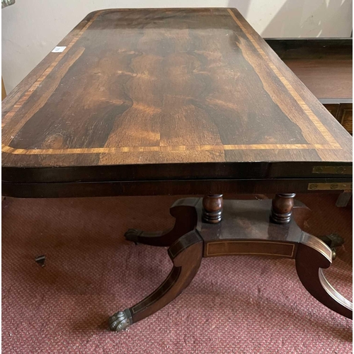 3174 - A Regency brass inlaid rosewood fold top card table on twin column supports and sabre legs. Height 7... 