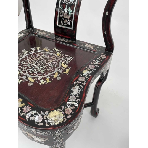 3177 - A pair of Chinese red lacquered corner armchairs, highly decorative with mother of pearl, the arms t... 