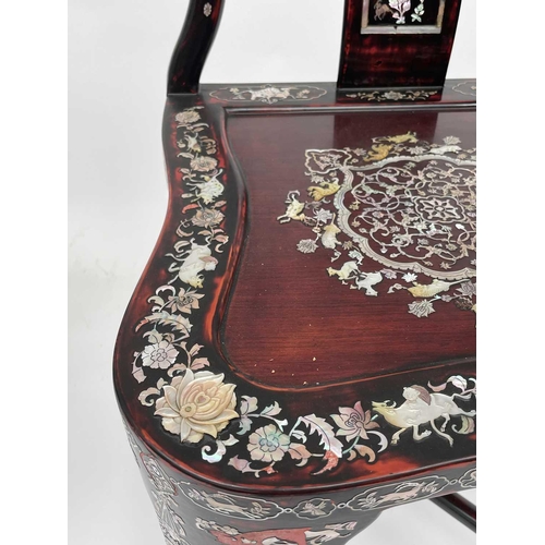 3177 - A pair of Chinese red lacquered corner armchairs, highly decorative with mother of pearl, the arms t... 