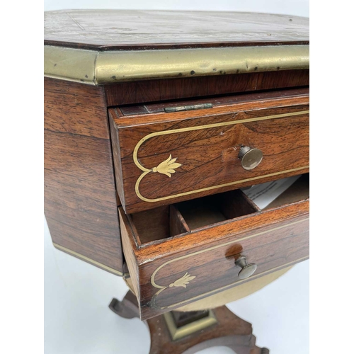 3184 - A Regency rosewood and brass inlaid work table, the octagonal top above two fitted drawers and dummy... 