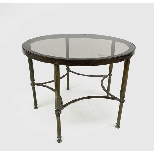 3193 - A glass topped gilt metal circular occasional table, raised on turned and fluted legs united by conc... 