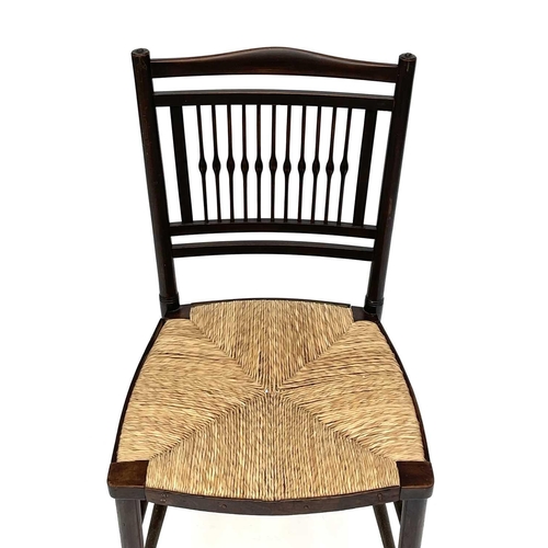 3201 - A walnut rush seated chair, early 20th century, in the Goodwin style, with spindle back.