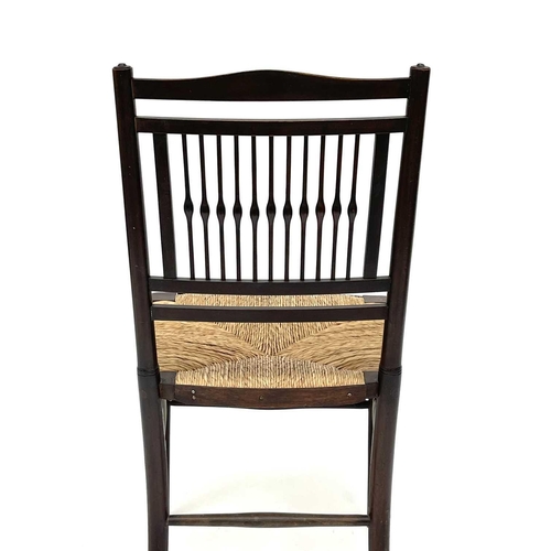 3201 - A walnut rush seated chair, early 20th century, in the Goodwin style, with spindle back.