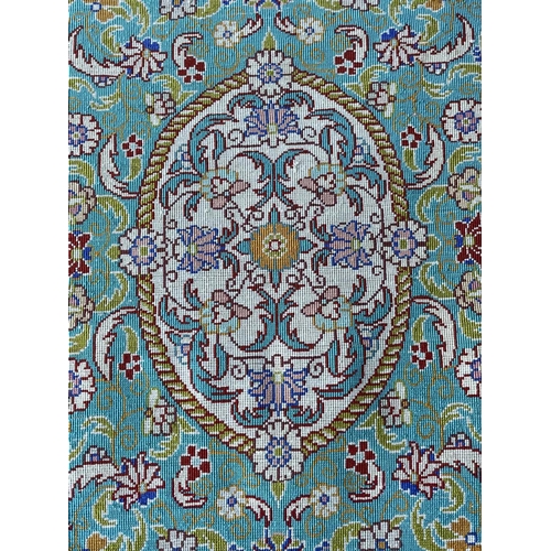 3202 - A Turkish silk rug, the pale blue field with an oval ivory medallion with scrolling flowering leafy ... 