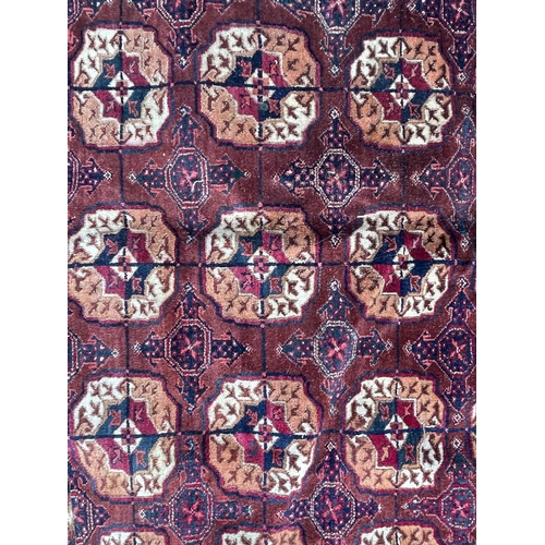 3203 - A Tekke Bokhara carpet, circa 1900-1920, with fourteen rows of five octagonal medallions, secondary ... 