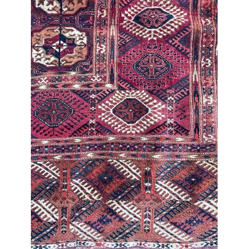 3203 - A Tekke Bokhara carpet, circa 1900-1920, with fourteen rows of five octagonal medallions, secondary ... 