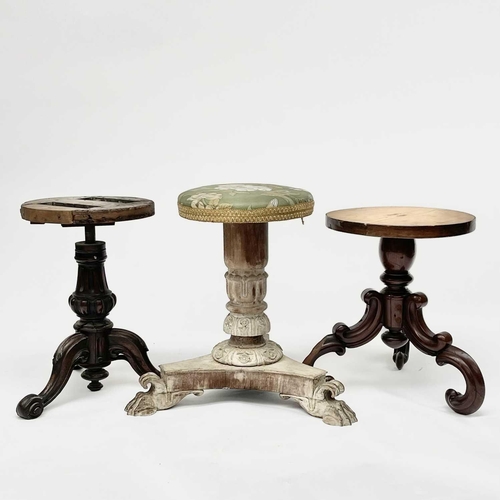 3215 - A Victorian mahogany revolving piano stool and two other stools.