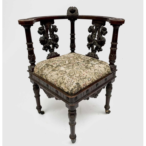 3223 - An Italian Renaissance carved oak corner chair, 19th century, the top rail carved with a cherubs mas... 