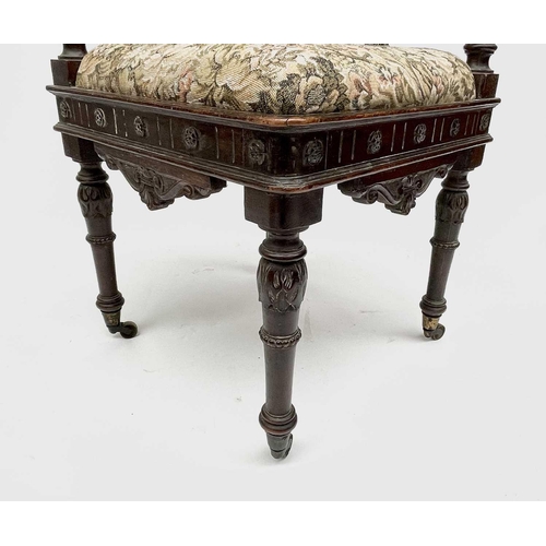 3223 - An Italian Renaissance carved oak corner chair, 19th century, the top rail carved with a cherubs mas... 