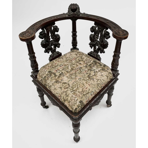 3223 - An Italian Renaissance carved oak corner chair, 19th century, the top rail carved with a cherubs mas... 