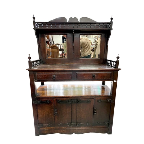 3224 - An Arts and Crafts oak mirror backed sideboard, height 153cm, width 104cm, depth 45cm.