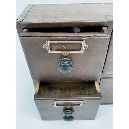 327 - A bank of Victorian stained pine apothecary drawers with turned ebonised handles. Height 31cm, width... 