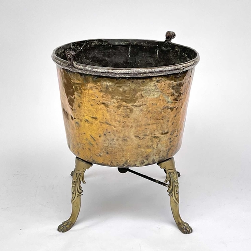 333 - A large brass cauldron or log bin, 19th century, raised upon four cast brass feet, height 75cm, diam... 