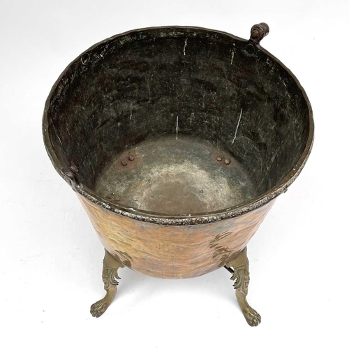 333 - A large brass cauldron or log bin, 19th century, raised upon four cast brass feet, height 75cm, diam... 