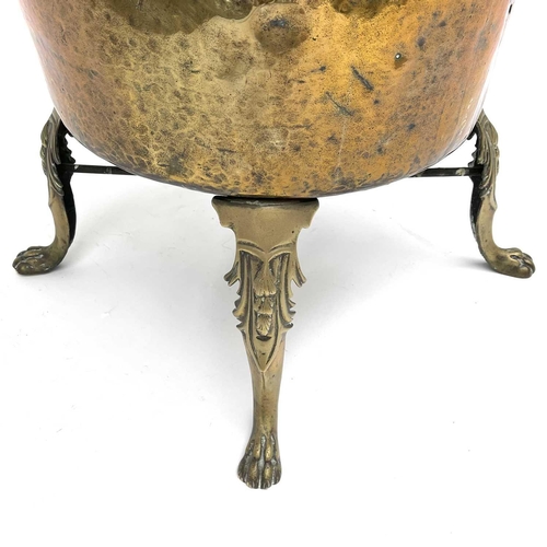 333 - A large brass cauldron or log bin, 19th century, raised upon four cast brass feet, height 75cm, diam... 