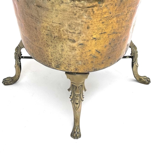 333 - A large brass cauldron or log bin, 19th century, raised upon four cast brass feet, height 75cm, diam... 