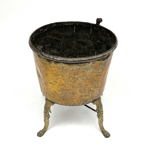 333 - A large brass cauldron or log bin, 19th century, raised upon four cast brass feet, height 75cm, diam... 