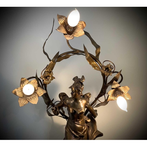 338 - A French Art Nouveau gilt spelter table lamp, modelled as a lady standing on a foliate base, the lea... 