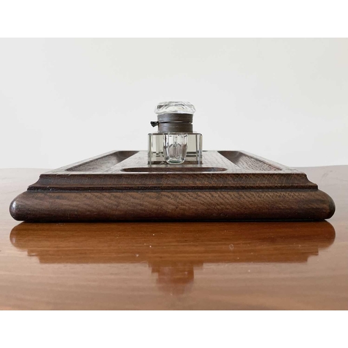 342 - An oak deskstand, circa 1920's, fitted with two glass inkwells, width 26cm.