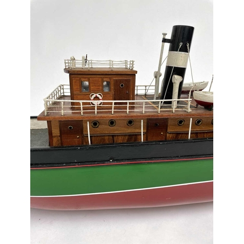 354 - A 20th century model of a steam boat, the hull painted in green and red. Overall length 110cm.