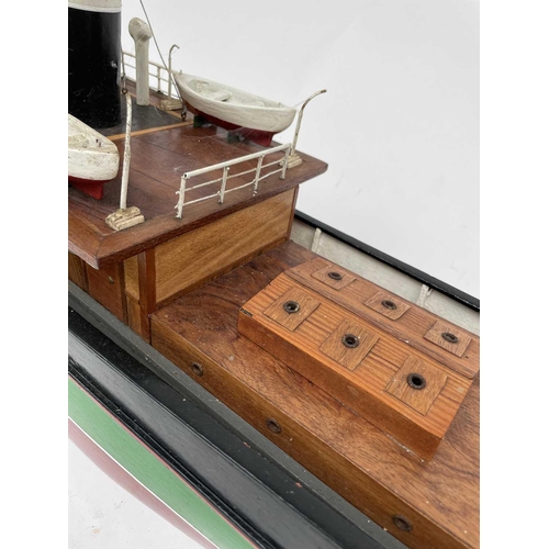 354 - A 20th century model of a steam boat, the hull painted in green and red. Overall length 110cm.