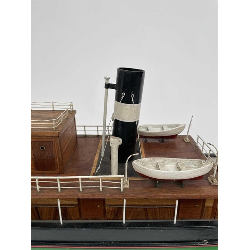 354 - A 20th century model of a steam boat, the hull painted in green and red. Overall length 110cm.