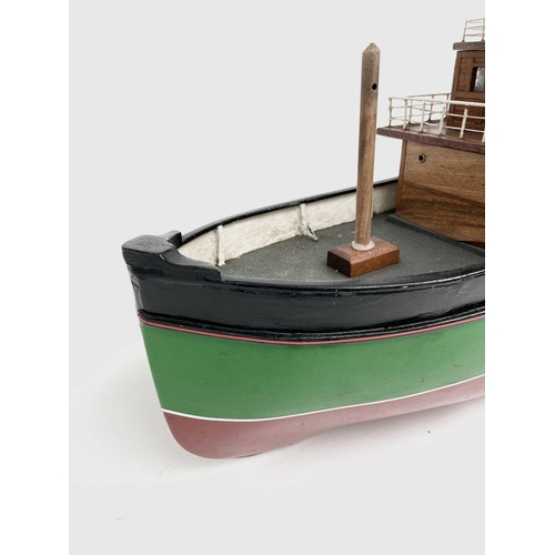 354 - A 20th century model of a steam boat, the hull painted in green and red. Overall length 110cm.